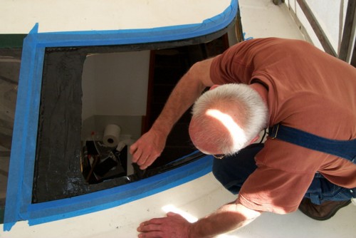 Installing new bathroom window on out Prout Escale Catamaran